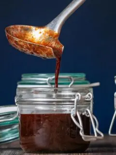 Square image of homemade Chinese plum sauce being decanted into storage jars