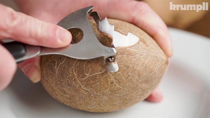Peeling a coconut after opening