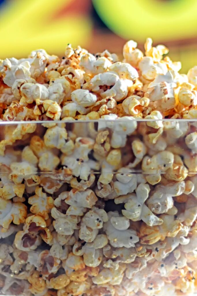 Portrait close up image of spiced popcorn in a glass bowl