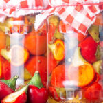 Portrait image of cherry bomb chillies in front of jars full of pickled chilli with text overlays