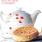 Portrait image of a toasted homemade English crumpet on a white plate in front of a teapot with text overlay