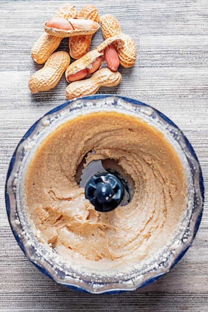Portrait image of homemade peanut butter being made in a mini blender