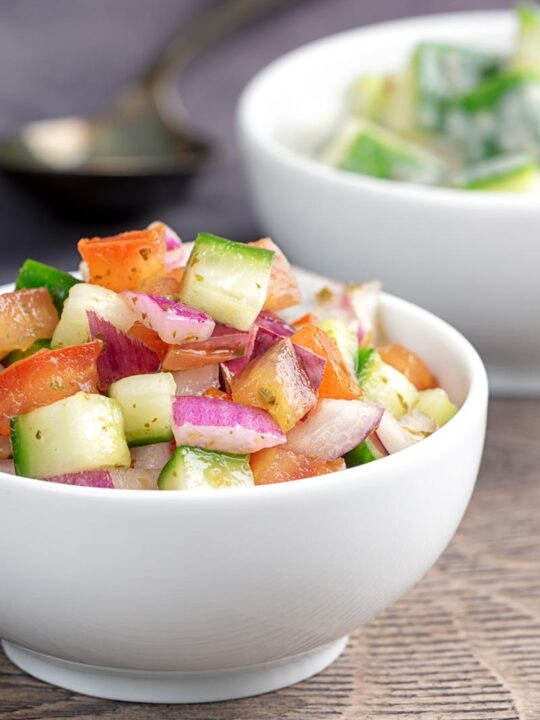 Portrait image of an Indian kachumber side salad served in a white bowl