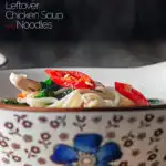 Portrait close up image of a steaming bowl of chicken noodle soup made with leftover chicken with text overlay
