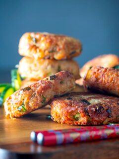 Portrait close up image of spicy Thai tuna fish cakes served with a cucumber and peanut salad