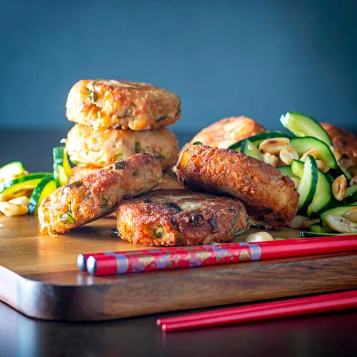 Square image of spicy Thai tuna fish cakes served with a cucumber and peanut salad