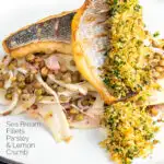 Portrait image of pan fried sea bream fillet served with a parsley crumb and puy lentils with fennel with text overlay