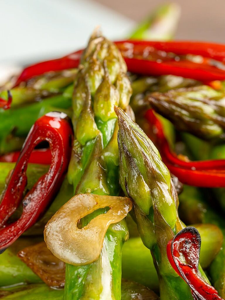 Portrait close up image of asparagus stir fry with chilli and garlic