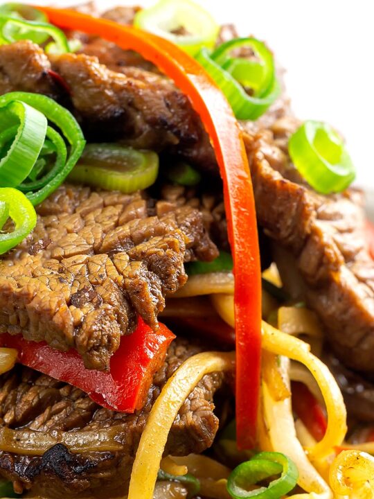 Portrait close up image of a beef stir fry with noodles, chilli and spring onions