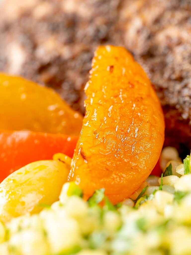 Portrait close up image of apricot slices in a rabbit tagine