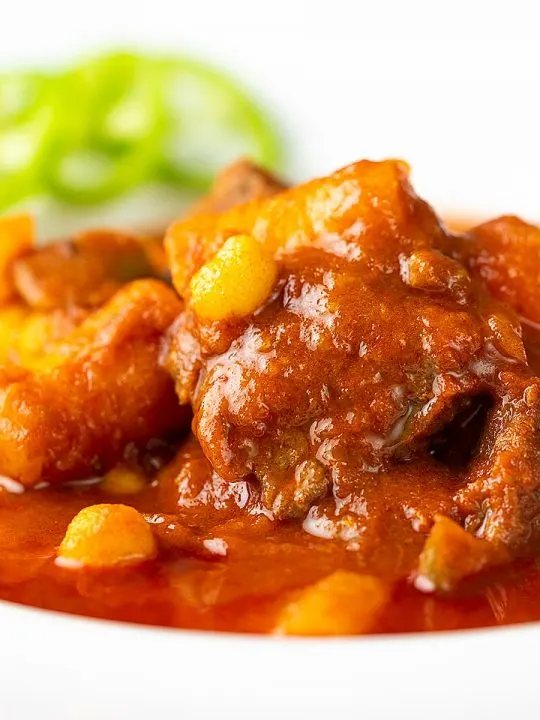 Portrait close up image of a Traditional Hungarian beef goulash or gulyasleves with handmade csipetke (pasta)