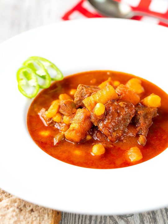 Portrait image of a Traditional Hungarian beef goulash or gulyasleves with handmade csipetke (pasta)
