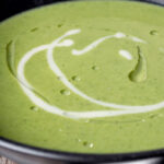 Portrait close up image of a creamy broccoli and stilton soup with a text overlay