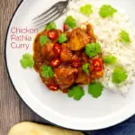 Portrait overhead image of a chicken pathia or patia curry served on a plate with rice, chilli slices and fresh coriander with text overlay