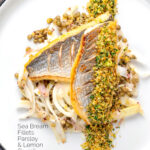 Portrait overhead image of pan fried sea bream fillet served with a parsley crumb and puy lentils with fennel with text overlay