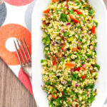 Portrait overhead image of a herby tabbouleh salad served in a white bowl