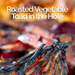 Portrait close up image of a roasted vegetable toad in the hole cooked and served in a cast iron pan with text overlay