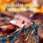 Portrait close up image of a roasted vegetable toad in the hole cooked and served in a cast iron pan with text overlay