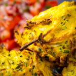 Portrait close up image of crispy air fryer onion bhaji or pakora with text overlay