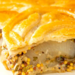 Portrait close up image of a slice of cheese and onion pie with potatoes and mustard served on a plate with a text overlay