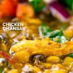 Portrait close up image of an Indian Chicken Dhansak lentil curry served with a kachumber salad with a text overlay