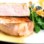 Portrait close up image of a pork loin steak sliced to show the moist interior