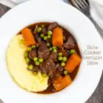 Portrait over head image of a slow cooker venison stew or casserole served with peas, carrots and mashed potato with a text overlay
