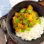 Portrait overhead image of a Burmese influenced vegan pumpkin curry served with white rice and fresh coriander with a text overlay