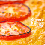 Portrait close up image of cheese and potato pie bake topped with tomato slices featuring a text overlay