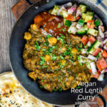Portrait overhead image of a vegan chickpea and lentil curry served in an iron kadai with mango chutney and kachumber salad and chapatis featuring a text overlay