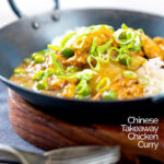 Portrait image of a takeaway influenced Chinese chicken curry with garden peas and spring onions featuring a text overlay