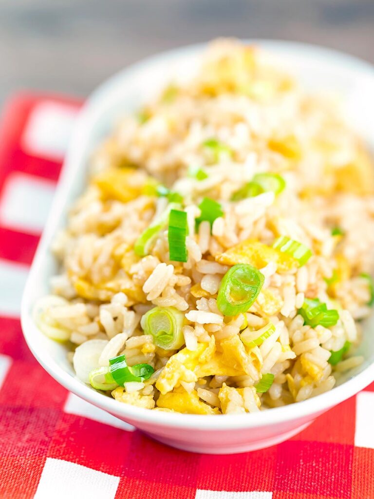 Portrait image of quick egg fried rice served in a white bowl