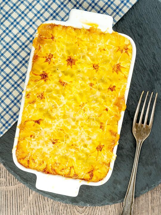 Portrait overhead image of a vegetarian shepherds pie or shepherdess pie served in a white gratin dish