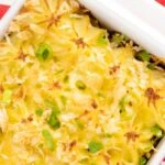 Portrait close up overhead image of an individual cheesy cumberland pie served in a white gratin dish