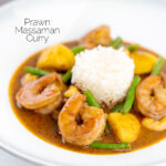 Portrait image of a Thai Prawn Massaman Curry with potatoes and green beans served in a white bowl featuring a text overlay