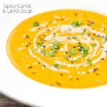 Portrait image of a spicy carrot and lentil soup spiced with harissa paste and garnished with a swirl of tahini served in a white bowl featuring a title overlay