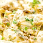 Portrait close up image of homemade spinach and ricotta ravioli with a lemon caper butter sauce