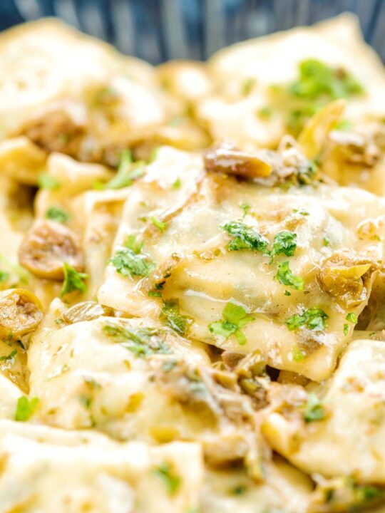 Portrait close up image of homemade spinach and ricotta ravioli with a lemon caper butter sauce