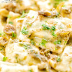 Portrait close up image of homemade spinach and ricotta ravioli with a lemon caper butter sauce featuring a title overlay