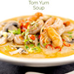 Portrait image of a Thai Prawn Tom Yom Soup served in a white soup bowl featuring a title overlay