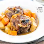 Portrait image of a lamb neck stew using bone in lamb neck chops, potatoes, carrots and parsnips served in a white bowl featuring a text overlay
