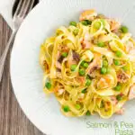 Portrait overhead image of salmon and pea pasta with tagliatelle pasta and crispy salmon skin and snipped chives featuring a title overlay