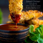 Crispy chicken goujons with one being dipped into a spicy dipping sauce featuring a title overlay