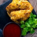 Overhead of chicken goujons in a hazelnut and breadcrumb with a spicy dipping sauce