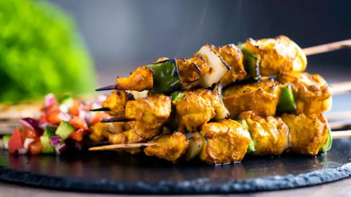 Steaming hot chicken tikka kebab with onion and green pepper served with kachumber salad