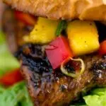 Close up Jamaican jerk chicken burger with a mango salsa