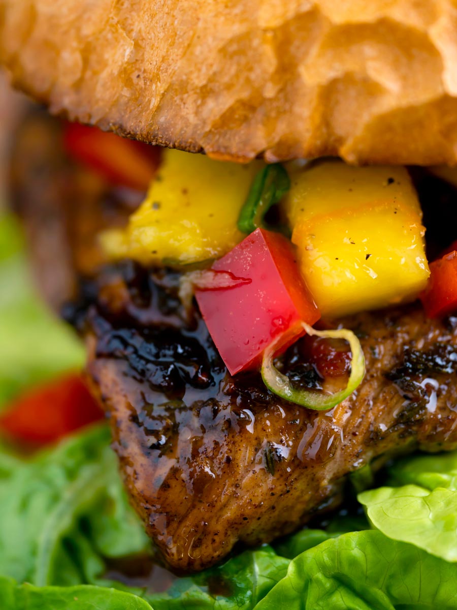 Close up Jamaican jerk chicken burger with a mango salsa