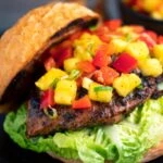 Jamaican jerk chicken burger with a mango salsa served on a toasted bun