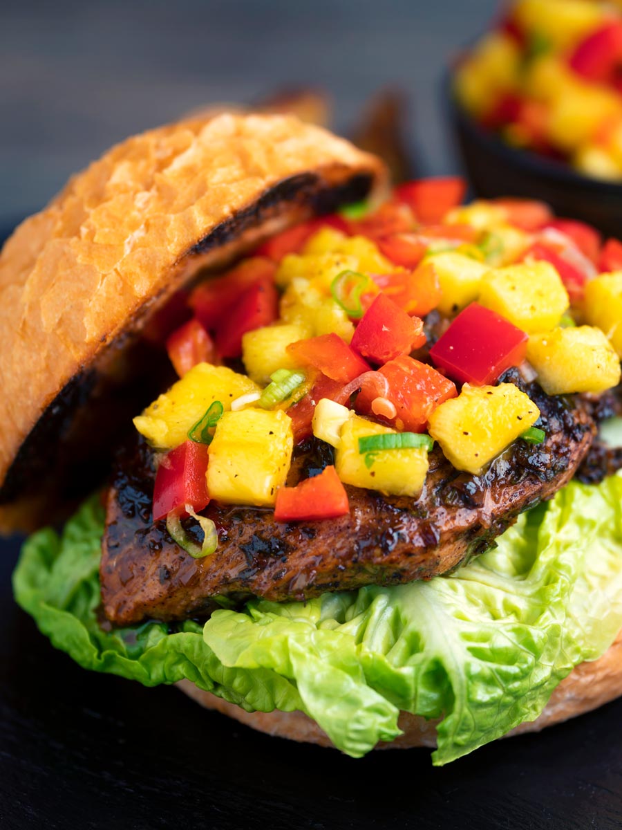 Jamaican jerk chicken burger with a mango salsa served on a toasted bun