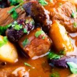 Close up Hungarian bean goulash or babgulyas served in an iron bowl.